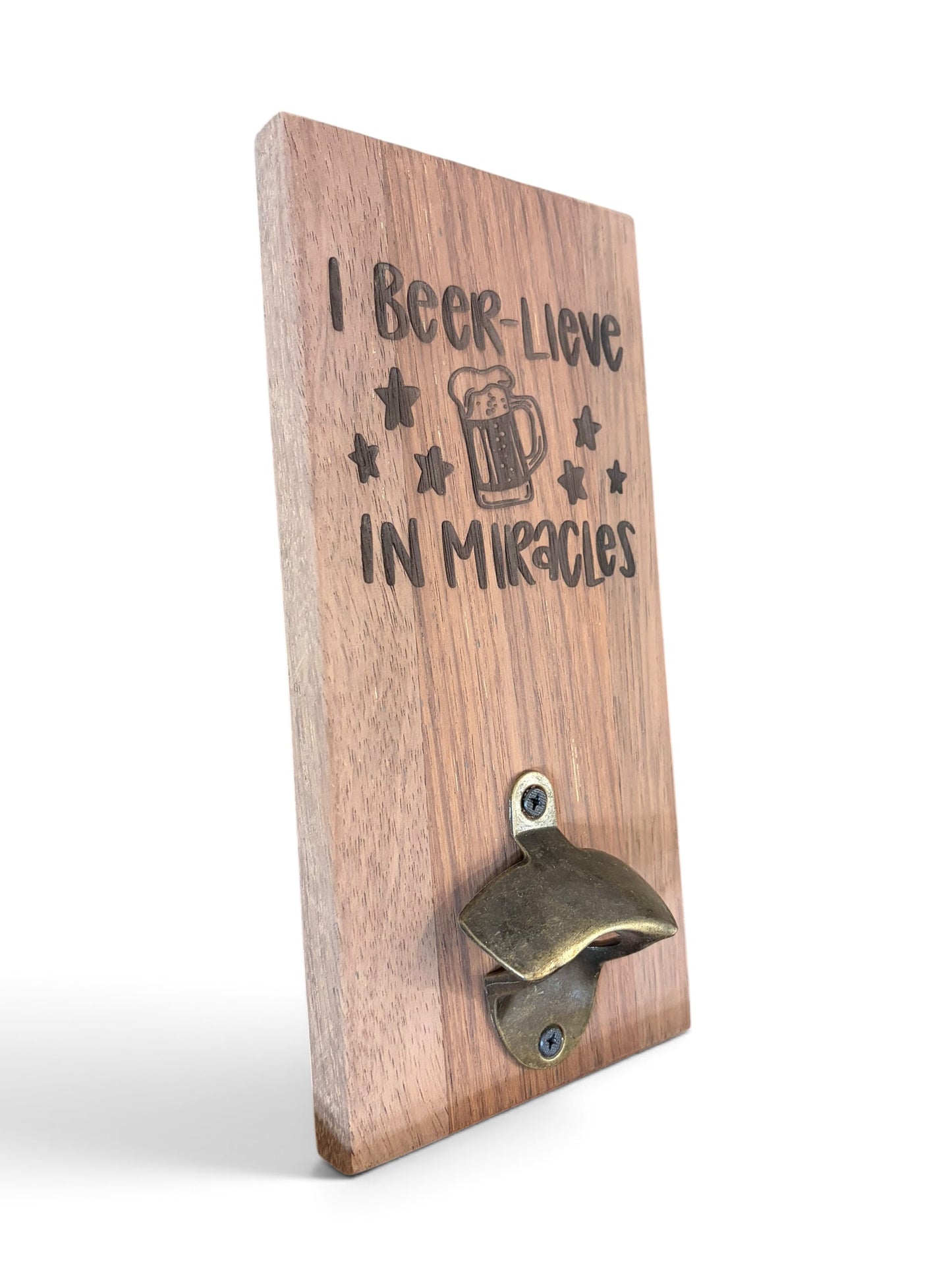 A wooden wall-mounted bottle opener with the engraved text 'I Beer-Lieve IN Miracles' and a beer mug graphic, shown on a white background.