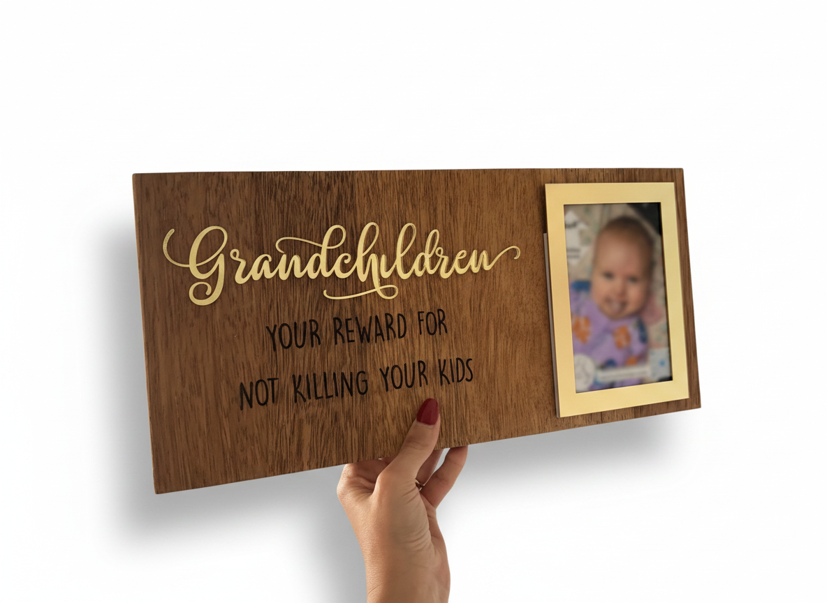 Wooden plaque with gold text and a photo frame held by a hand.