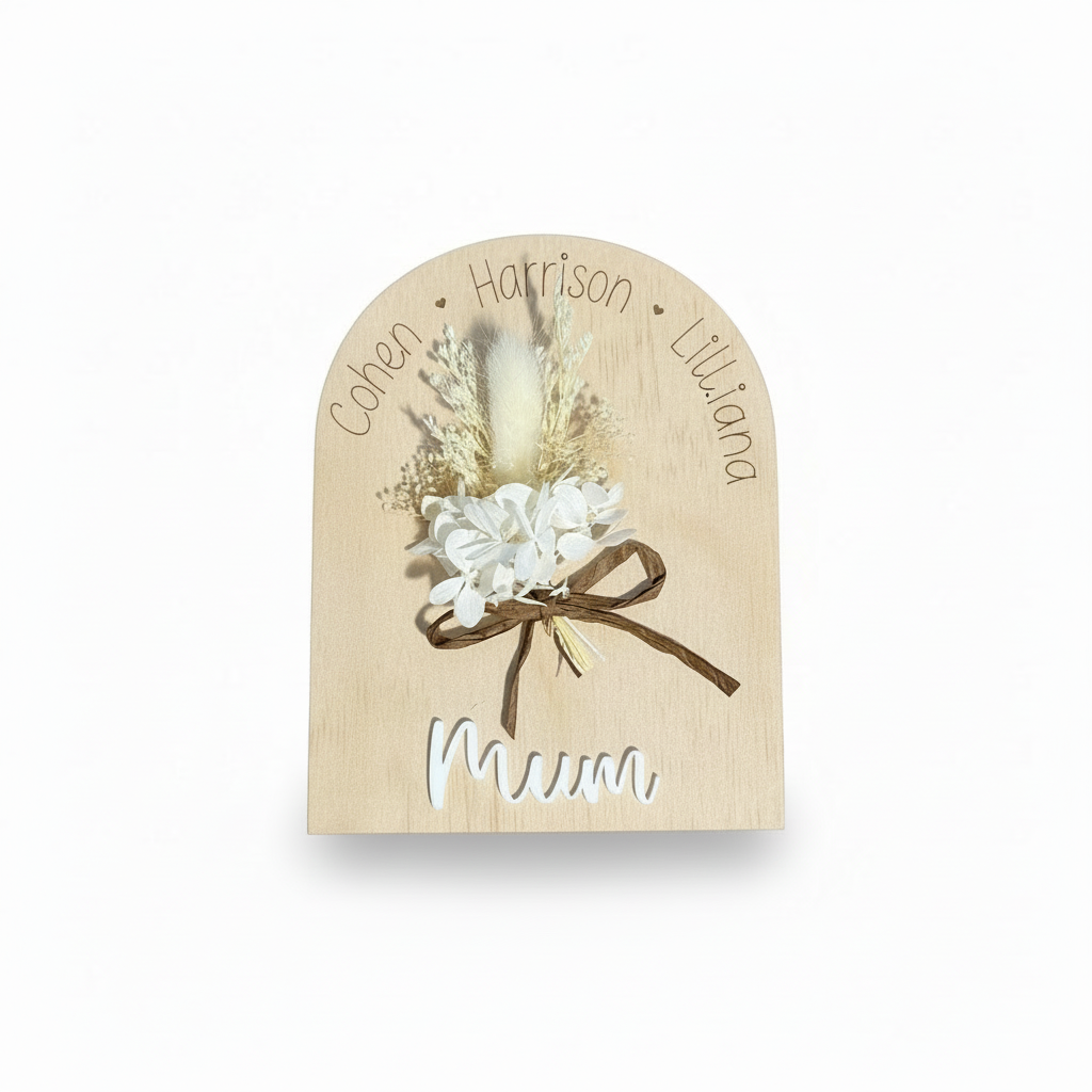 Wooden plaque with floral design and names on a white background
