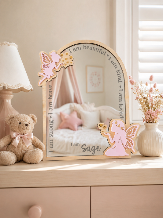 Personalised fairy affirmation mirror styled on a dresser in a child’s bedroom with soft, warm decor.