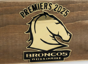 Wooden plaque with hooks featuring a bronco logo and text on a white background