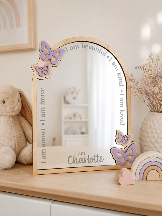 Personalised butterfly affirmation mirror made from plywood and mirrored acrylic featuring engraved positive affirmations and a custom name for a child's bedroom.