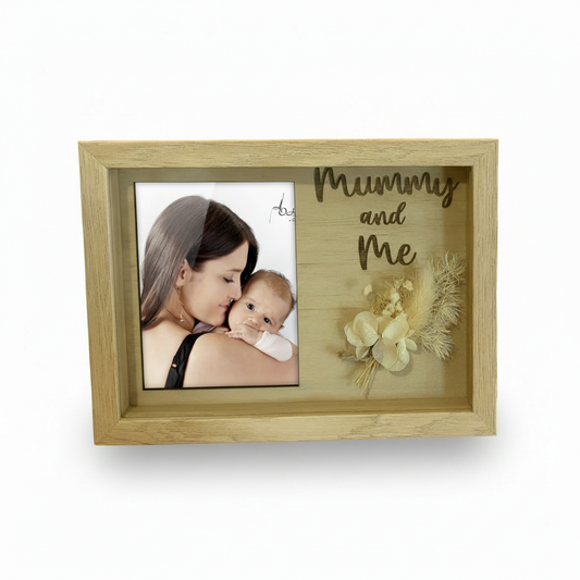 Wooden photo frame with 'Mummy and Me' text and a photo of a woman holding a baby.