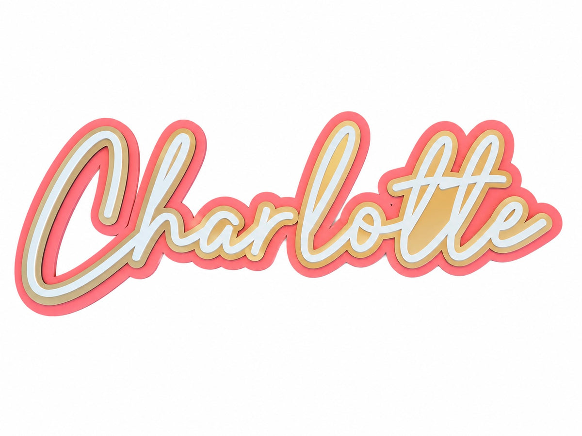A 3D cursive script wall sign reading 'Charlotte' in cream lettering with a pink outer border and a yellow inner border, shown on a plain white background.
