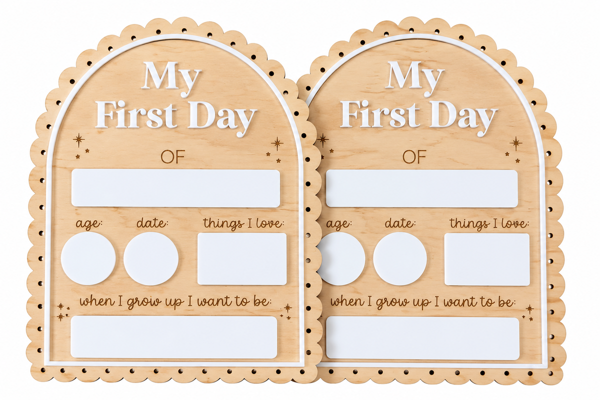 Two matching wooden arch-shaped milestone plaques labeled 'My First Day OF' with blank photo frames, age/date fields, and text for when grown up, shown on a white background.