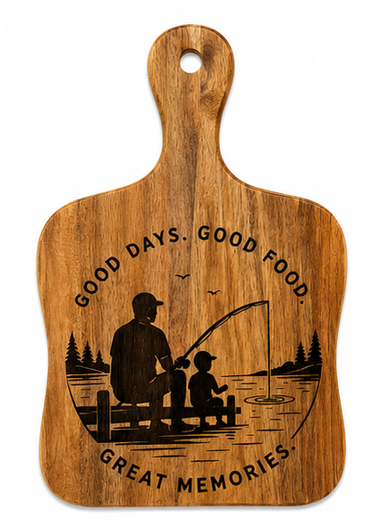A wooden cutting board with a handle, featuring an engraved design of a father and child fishing on a dock with the text 'GOOD DAYS. GOOD FOOD. GOOD MEMORIES'