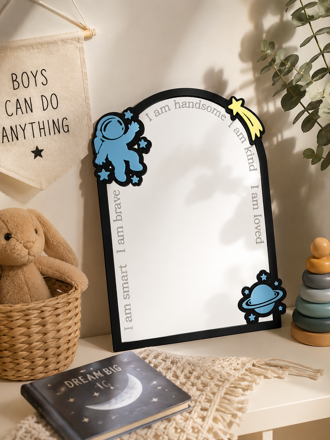 Personalised space-themed acrylic affirmation mirror featuring a blue astronaut, planet, shooting star and engraved positive affirmations in a child's bedroom.