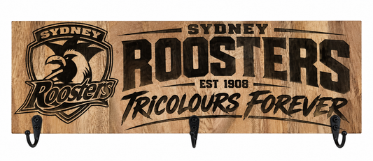 A rectangular wooden wall sign with black metal hooks at the bottom, featuring the Sydney Roosters logo and team text on a natural wood background.